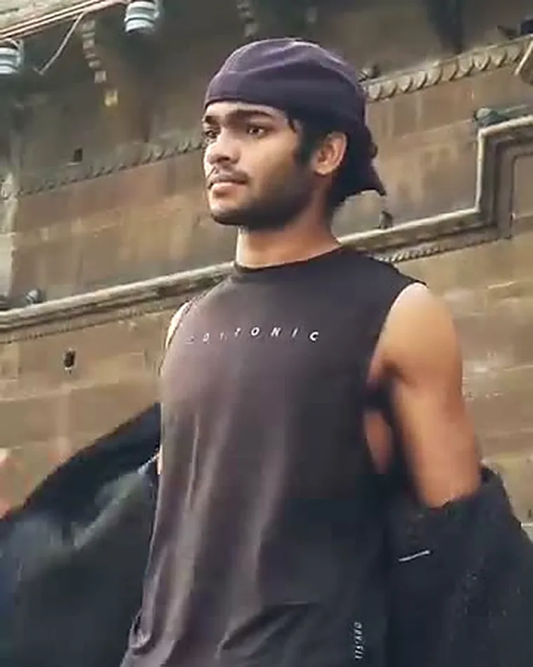 Coach Alok standing outdoors in Varanasi after training