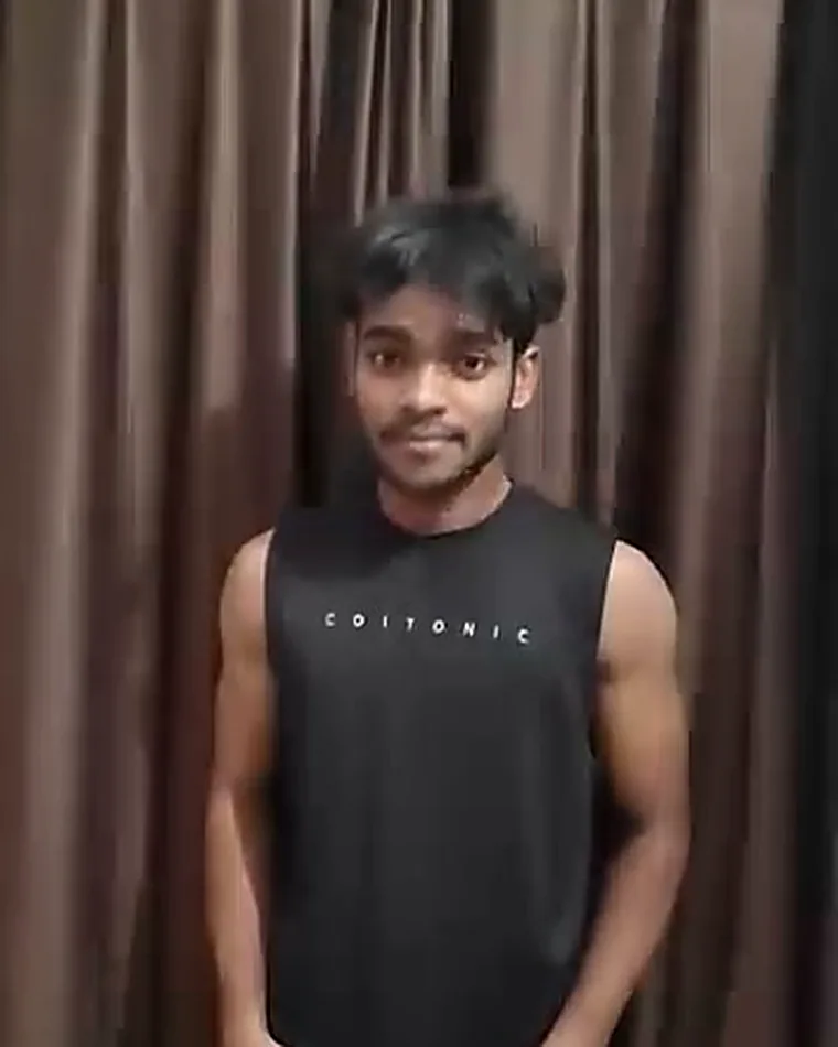 Coach Alok in a training vest, showing his physique