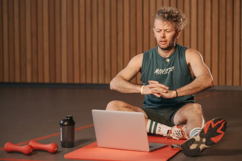 A person following a training session on a laptop